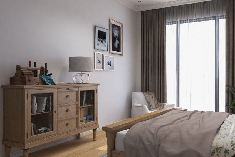 Stylish bedroom with a wooden cabinet, cozy decor, and soft natural lighting.