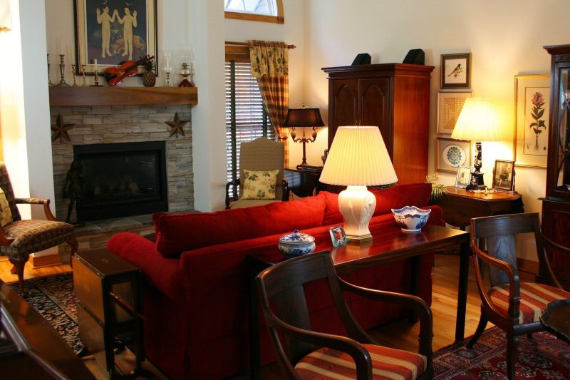 Warm living room with classic furniture, a fireplace, and cozy decor, ideal for inviting gatherings.