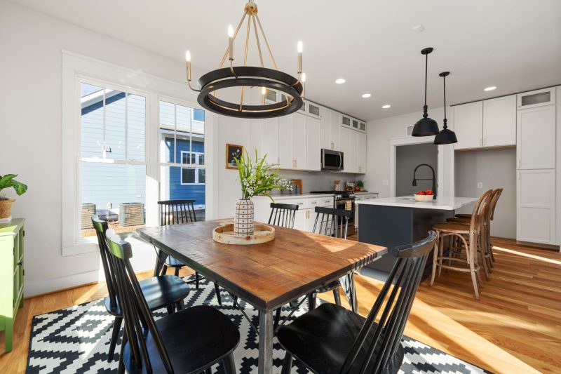 Home 15 Bright, modern kitchen and dining area featuring stylish furnishings and abundant natural light.
